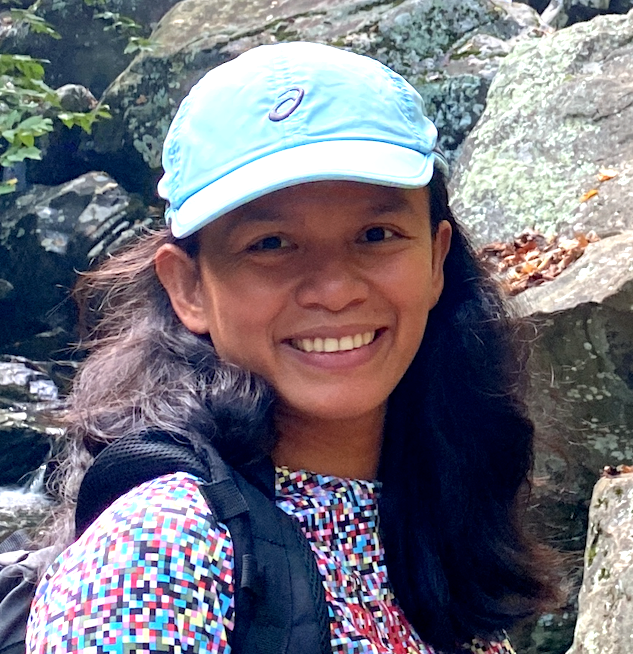 image of developer outdoors with a background of river rocks